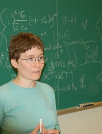 Picture of Heather standing in front of a chalkboard